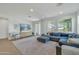 Bright living room featuring a large sectional sofa and access to a patio at 1876 S Huish Dr, Gilbert, AZ 85295