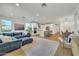 Open-concept living area flows to a white kitchen with island and dining area at 1876 S Huish Dr, Gilbert, AZ 85295