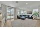 Bright living room with a plush sectional sofa, large windows, and seamless access to the outdoor space at 1876 S Huish Dr, Gilbert, AZ 85295