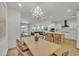 Open living and dining area featuring a modern chandelier, with sight lines into the kitchen and Gathering room at 1876 S Huish Dr, Gilbert, AZ 85295