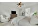 Spacious main bedroom with a large dresser, TV, and sitting area at 1876 S Huish Dr, Gilbert, AZ 85295