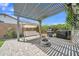 Back patio featuring a swing, grill, and a modern pergola at 1876 S Huish Dr, Gilbert, AZ 85295