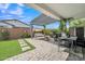 Relaxing outdoor patio with pergola, swing, grill, dining table and lush plants at 1876 S Huish Dr, Gilbert, AZ 85295