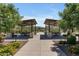 Community picnic area with shaded pavilions, tables, and landscaping under a sunny sky at 1876 S Huish Dr, Gilbert, AZ 85295