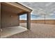 Covered patio overlooking a low-maintenance backyard with gravel and a block wall, offering privacy and outdoor space at 19002 N Toledo Ave, Maricopa, AZ 85138