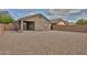 Backyard featuring gravel landscaping and a block wall, providing a low-maintenance outdoor space and security at 19002 N Toledo Ave, Maricopa, AZ 85138