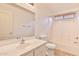 Bright bathroom with a single vanity, a toilet, and a shower-tub combination with a neutral color palette at 19002 N Toledo Ave, Maricopa, AZ 85138