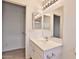 Bright bathroom featuring a single vanity, a well-lit mirror, and a doorway, providing convenience and style at 19002 N Toledo Ave, Maricopa, AZ 85138