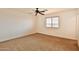 Cozy bedroom with carpet, a ceiling fan, and a window with blinds, offering comfortable living space at 19002 N Toledo Ave, Maricopa, AZ 85138