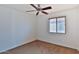 A cozy bedroom features a ceiling fan and natural light from the window, creating a relaxing atmosphere at 19002 N Toledo Ave, Maricopa, AZ 85138
