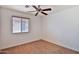 Comfortable bedroom with a ceiling fan, window, and neutral decor for a versatile space at 19002 N Toledo Ave, Maricopa, AZ 85138
