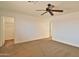 Spacious bedroom featuring a ceiling fan, neutral carpet and paint, and ample space at 19002 N Toledo Ave, Maricopa, AZ 85138