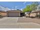 Charming single-story home with a well-maintained yard, a two-car garage, and desert landscaping at 19002 N Toledo Ave, Maricopa, AZ 85138