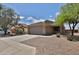 Single-story home with a two-car garage and desert landscaping is bathed in natural light at 19002 N Toledo Ave, Maricopa, AZ 85138