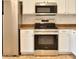 Stainless steel appliances and white cabinets accent this well-lit kitchen at 19002 N Toledo Ave, Maricopa, AZ 85138