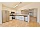 Bright kitchen with white cabinets, stainless steel appliances, and tiled floors at 19002 N Toledo Ave, Maricopa, AZ 85138