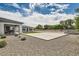 Spacious backyard featuring a large decorative stone area, a covered patio, and meticulously designed landscaping at 19935 E Via Del Palo --, Queen Creek, AZ 85142