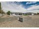 Extensive backyard featuring decorative rock, a covered patio, a green lawn, and lush landscaping at 19935 E Via Del Palo --, Queen Creek, AZ 85142