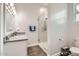 A well-lit bathroom showcasing a glass shower, sleek vanity with a gray countertop, and modern fixtures at 19935 E Via Del Palo --, Queen Creek, AZ 85142