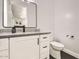 Cozy half-bathroom with sleek fixtures, a floating vanity, gray countertop, and modern toilet, providing a functional design at 19935 E Via Del Palo --, Queen Creek, AZ 85142