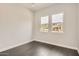 This modern bedroom features stylish wood floors and bright windows, offering ample natural light at 19935 E Via Del Palo --, Queen Creek, AZ 85142