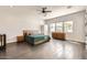 Tranquil bedroom with wood floors, a ceiling fan, a neutral color scheme, and natural light streaming through three windows at 19935 E Via Del Palo --, Queen Creek, AZ 85142