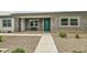 Inviting single story home featuring desert landscaping, a covered front porch, and gray brick accents at 19935 E Via Del Palo --, Queen Creek, AZ 85142