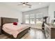 The main bedroom offers lots of light from large windows, a ceiling fan, and sleek wood floors at 19935 E Via Del Palo --, Queen Creek, AZ 85142
