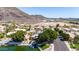 Aerial view features waterfront home with a dock and landscaping, in a neighborhood with mountain views at 20410 N 51St Dr, Glendale, AZ 85308