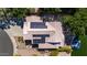 Aerial view of roof with solar panels, tile roof, mature trees and a glimpse of waterfront in the backyard at 20410 N 51St Dr, Glendale, AZ 85308