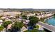Aerial view showcases waterfront home with a dock on the lake and mature trees in a residential neighborhood at 20410 N 51St Dr, Glendale, AZ 85308