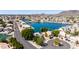 Stunning aerial view of waterfront homes, showcasing a tranquil lake community with lush greenery and convenient street access at 20410 N 51St Dr, Glendale, AZ 85308