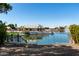 Exterior shot of fenced backyard with lake view, showcasing the area and neighborhood view beyond at 20410 N 51St Dr, Glendale, AZ 85308