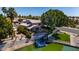 Waterfront home with boat dock, lush lawn and mature trees, offering serene lakeside living with direct water access at 20410 N 51St Dr, Glendale, AZ 85308