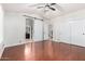Bright bedroom with hardwood floors, barn door, and access to the ensuite bathroom at 20410 N 51St Dr, Glendale, AZ 85308
