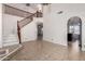Bright entryway with staircase, decorative chandelier, and arched doorways leading to other rooms at 20410 N 51St Dr, Glendale, AZ 85308
