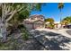 Charming two-story home with three-car garage, tile roof, desert landscaping and shade trees at 20410 N 51St Dr, Glendale, AZ 85308