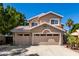 Charming two-story home featuring a three-car garage, neutral stucco, and a tile roof at 20410 N 51St Dr, Glendale, AZ 85308