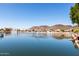 Scenic lake view with waterfront homes nestled against a backdrop of rolling hills, showcasing a serene community at 20410 N 51St Dr, Glendale, AZ 85308