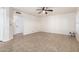 Neutral-toned living room featuring tile flooring, bright lighting, and open space at 20410 N 51St Dr, Glendale, AZ 85308