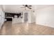 Open-concept living room featuring tile flooring, and a view of the kitchen with stainless steel appliances at 20410 N 51St Dr, Glendale, AZ 85308