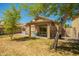 Cozy backyard featuring a covered patio, desert landscaping, and secure fencing at 22191 W Tonto St, Buckeye, AZ 85326