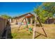 Spacious backyard with lush lawn and a charming swing set at 22191 W Tonto St, Buckeye, AZ 85326