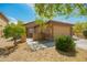 Tan exterior with tile roof, desert landscaping, and a well-kept front yard at 22191 W Tonto St, Buckeye, AZ 85326