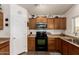 Well-lit kitchen featuring wood cabinetry and modern appliances at 22191 W Tonto St, Buckeye, AZ 85326