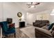 Relaxing living room with vaulted ceiling, ceiling fan, and comfortable reclining sofa at 22191 W Tonto St, Buckeye, AZ 85326