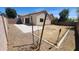 Backyard with extended patio space, partially xeriscaped and enclosed by block fence and mature trees at 2433 W Hayden Peak Dr, San Tan Valley, AZ 85144
