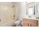 Bright bathroom featuring a tiled shower-tub combo, toilet, vanity with light wood cabinets and a sink at 2433 W Hayden Peak Dr, San Tan Valley, AZ 85144