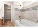 Beautifully remodeled bathroom features tile walls, a tub, and modern fixtures at 2433 W Hayden Peak Dr, San Tan Valley, AZ 85144