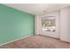 A light-filled bedroom features a vibrant wall and a large window at 2433 W Hayden Peak Dr, San Tan Valley, AZ 85144